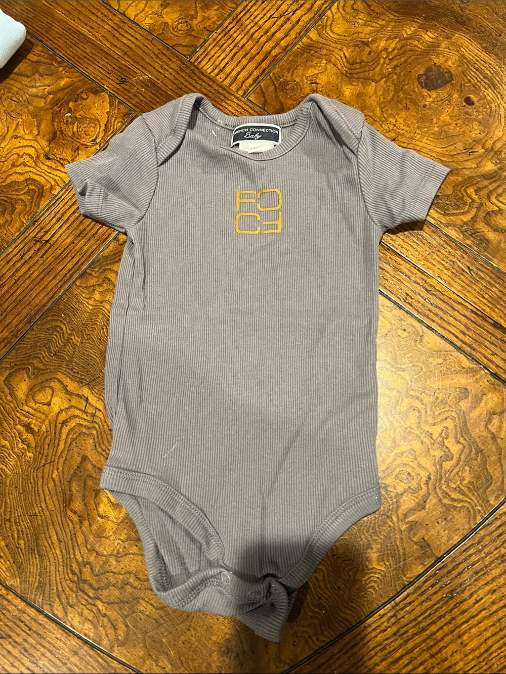 French Connection gray Ribbed Baby One-Piece with Gold Accent